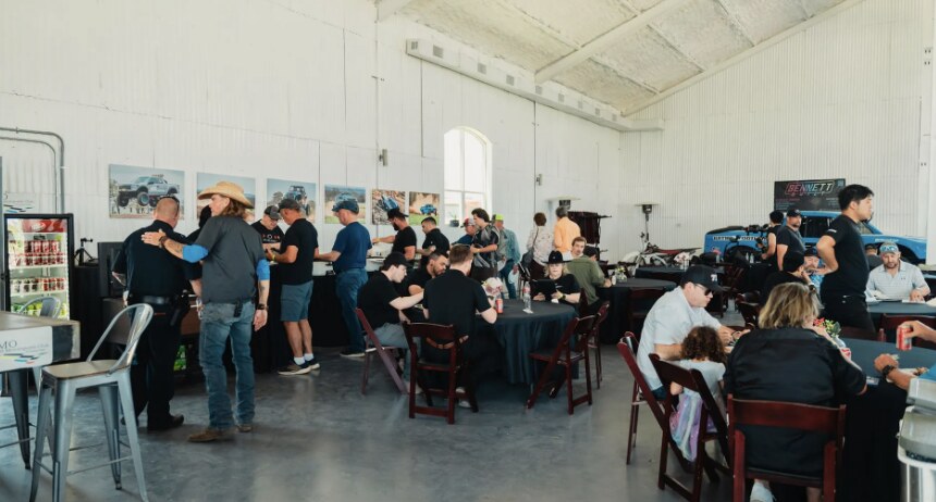 Tesla Owners Club of Austin members and families gathered indoors at a Cybertruck Rodeo event